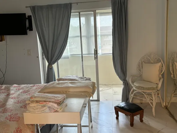 a view of a livingroom with furniture and a window