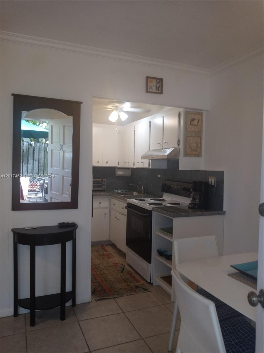 325 Fernwood Road, Unit 10 Key Biscayne, FL 33149 - Photo 12 of 12 a kitchen with a stove and a refrigerator