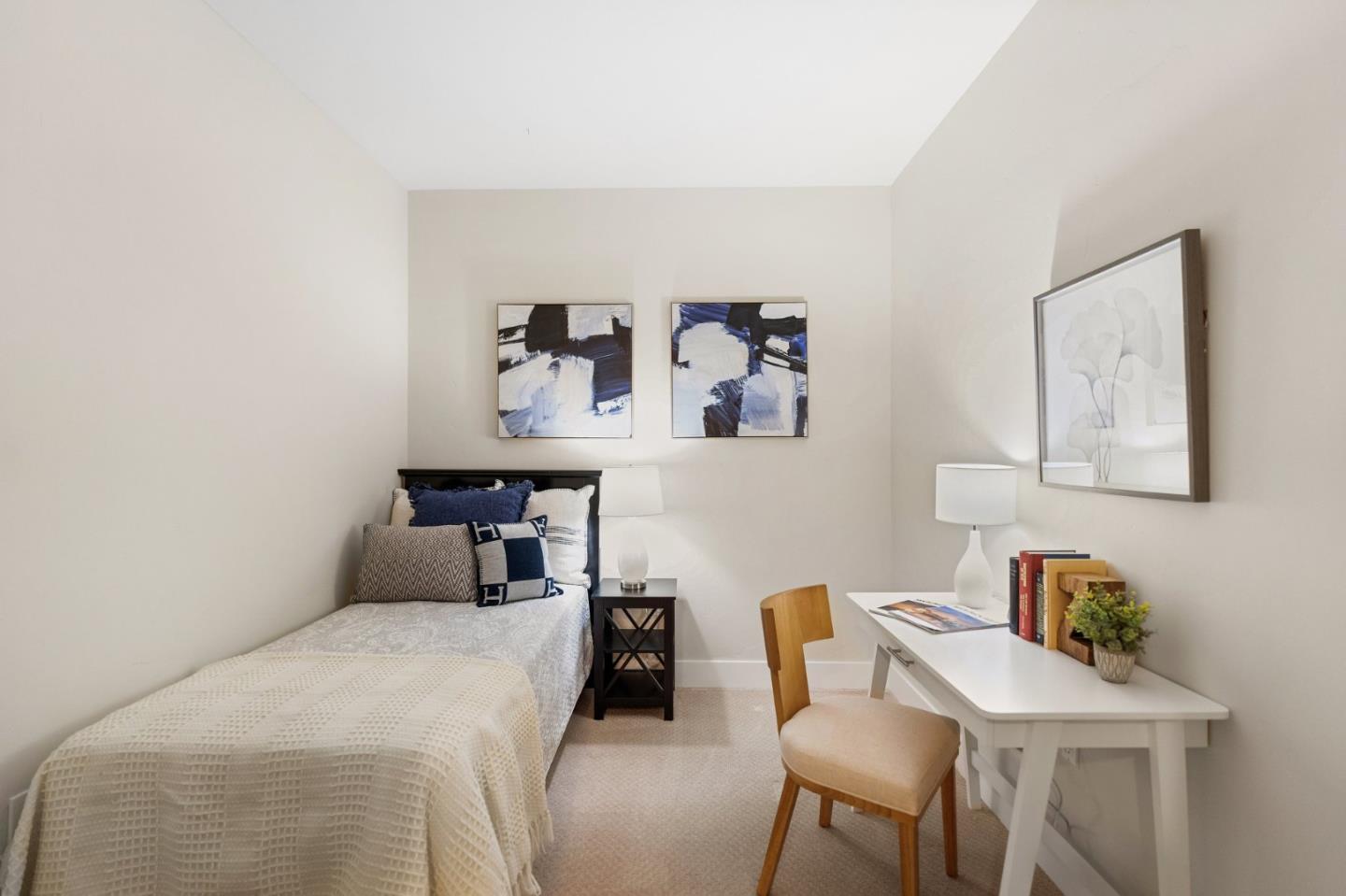 708 Frederick Street, Unit 204 Santa Cruz, CA 95062 - Photo 12 of 28 a bedroom with a bed and a table in it