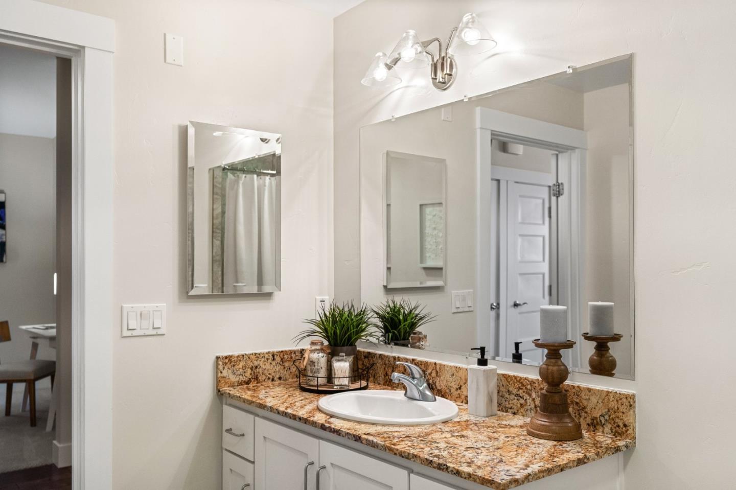 708 Frederick Street, Unit 204 Santa Cruz, CA 95062 - Photo 14 of 28 a bathroom with a granite countertop sink and a mirror