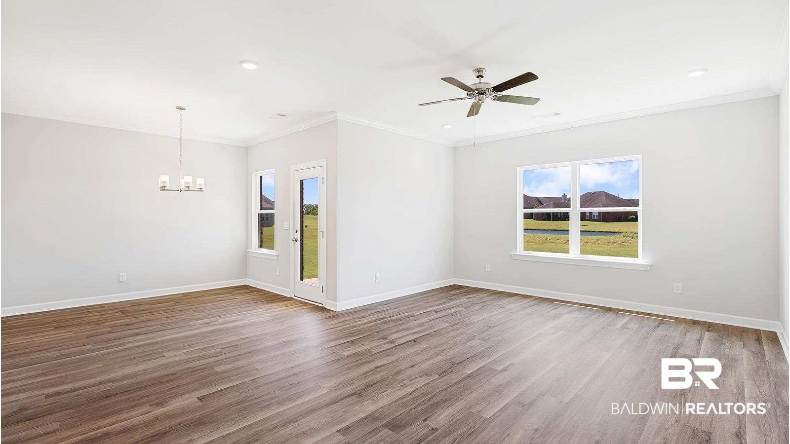 30567 Asheville Road Daphne, AL 36527 - Photo 11 of 29 Spare room featuring crown molding, a ceiling fan, light wood finished floors, a chandelier, and recessed lighting