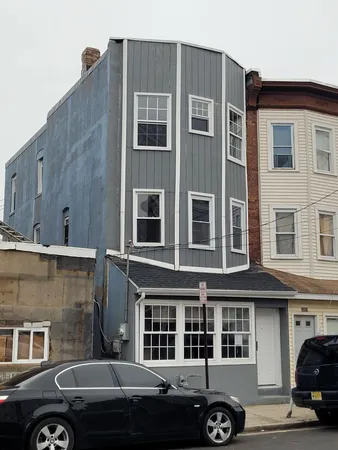 a couple of cars parked in front of a building