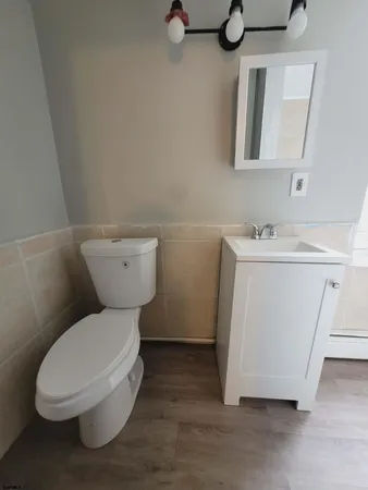 a white toilet sitting next to a bathroom sink