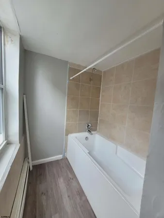 a bathroom with a bathtub and a sink