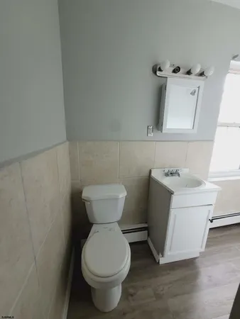 a bathroom with a toilet sink and mirror