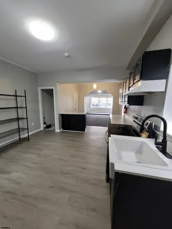 a kitchen with kitchen island a sink stainless steel appliances and window
