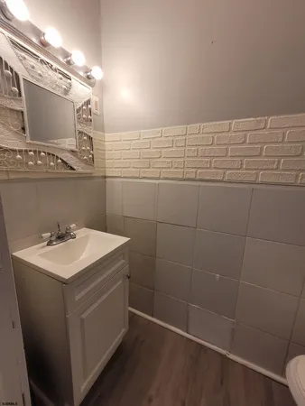 a bathroom with a sink a toilet and a mirror