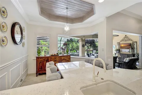 a large white kitchen with a large window