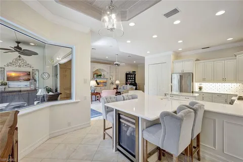 a large kitchen with kitchen island a dining table and chairs