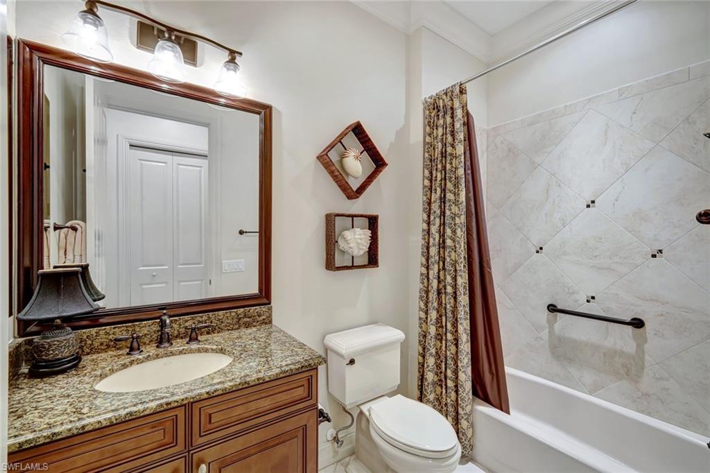 12441 Villagio Way Fort Myers, FL 33912 - Photo 22 of 32 a bathroom with a granite countertop toilet sink and mirror