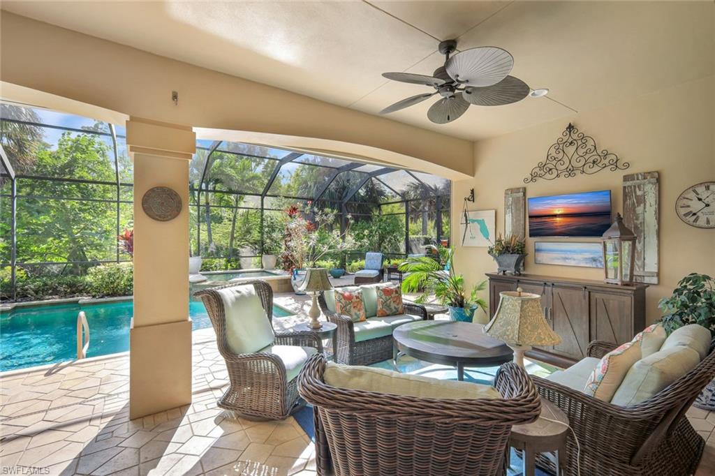 12441 Villagio Way Fort Myers, FL 33912 - Photo 26 of 32 a living room with fireplace furniture and a floor to ceiling window