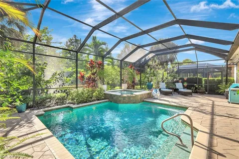 a view of a backyard with table and chairs under an umbrella