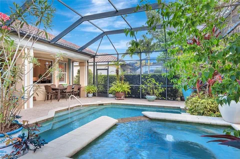 a view of a backyard with table and chairs under an umbrella