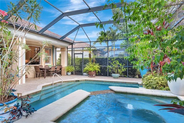 a view of a backyard with table and chairs under an umbrella