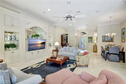 a living room with furniture a large window and a flat screen tv