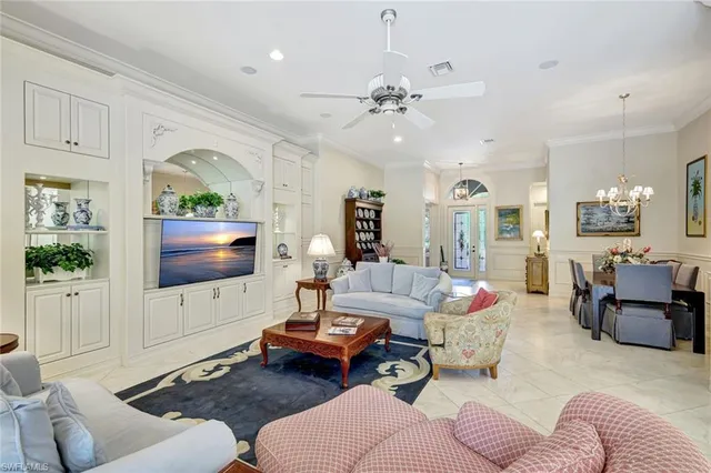 a living room with furniture a large window and a flat screen tv