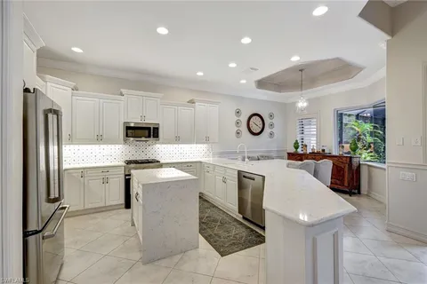 a kitchen with a sink cabinets and stainless steel appliances