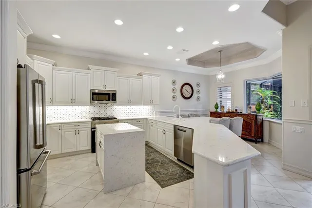 a kitchen with a sink cabinets and stainless steel appliances