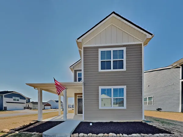 a front view of a house with a yard