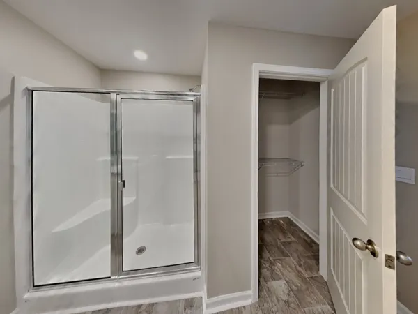 a bathroom with a glass shower door
