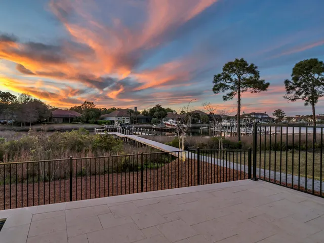 a front view of a house with a yard and lake view