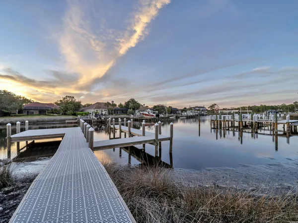 a view of roof deck with dining table and chairs
