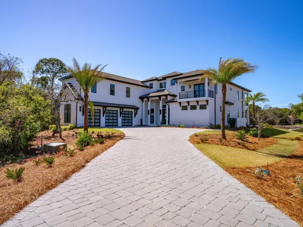 a view of a chairs and table on wooden deck with a lake view