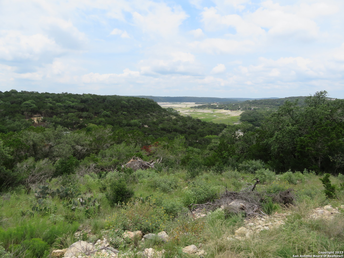 0 Hilltop Loop Lakehills, TX 78063 - Photo 17 of 32 a view of a green field with lots of trees
