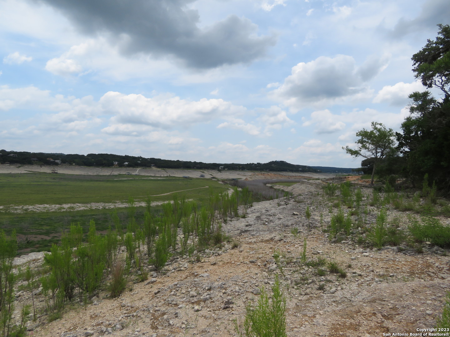 0 Hilltop Loop Lakehills, TX 78063 - Photo 18 of 32 a view of a lake from a yard