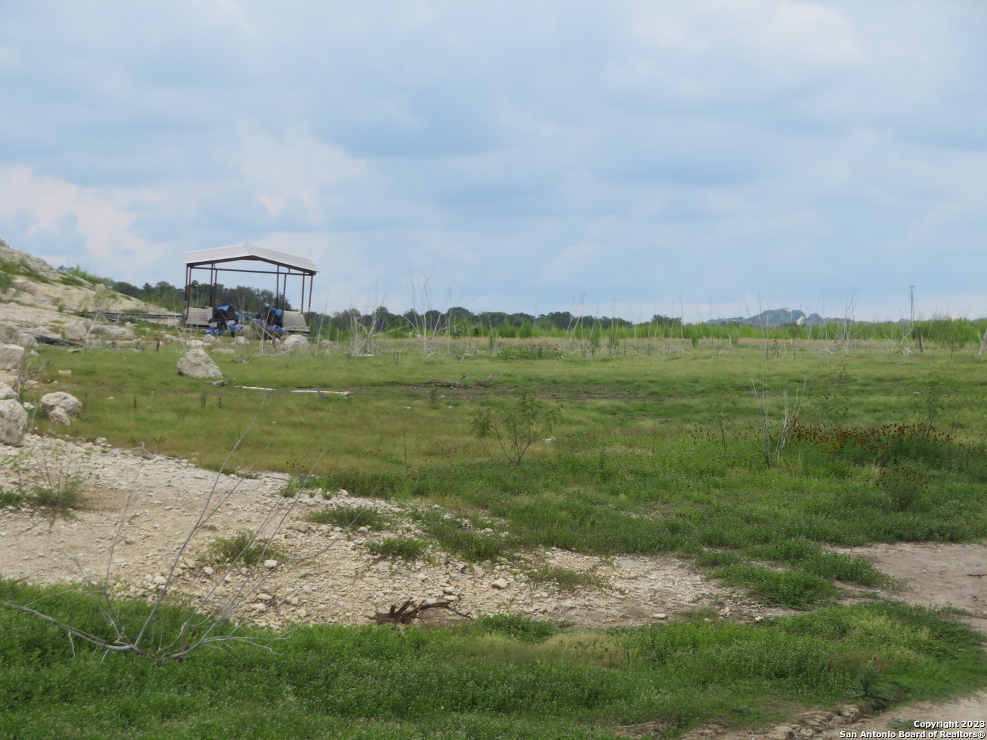 0 Hilltop Loop Lakehills, TX 78063 - Photo 22 of 32 a view of a grassy field with an trees