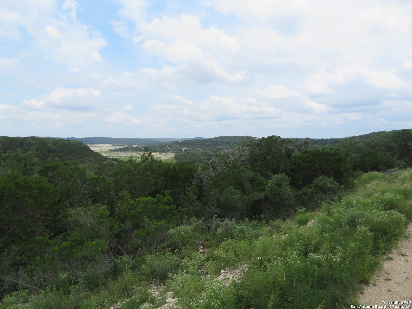 0 Hilltop Loop Lakehills, TX 78063 - Photo 27 of 32 a view of a green field with lots of bushes