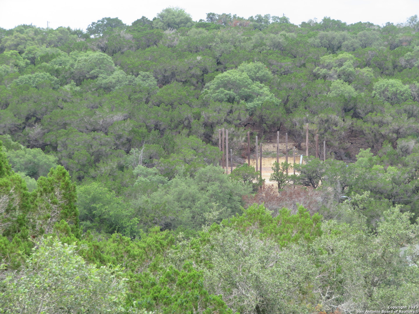 0 Hilltop Loop Lakehills, TX 78063 - Photo 6 of 32 a view of a forest with a street