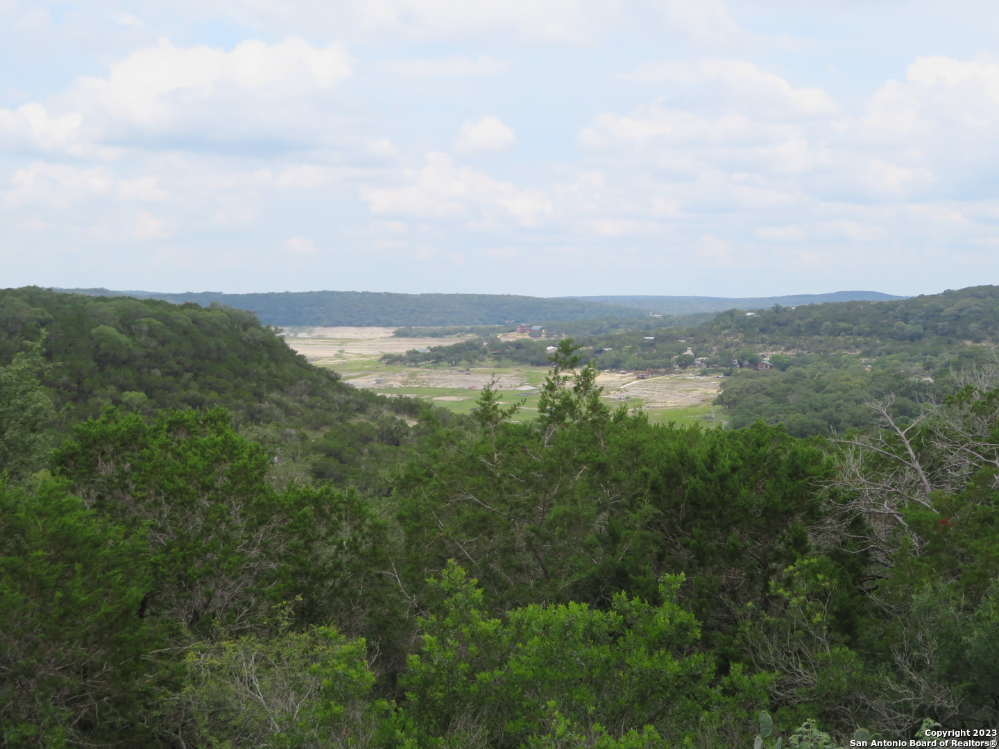 0 Hilltop Loop Lakehills, TX 78063 - Photo 9 of 32 an aerial view of residential houses with outdoor space and trees