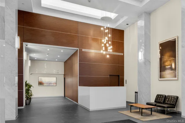 a lobby with furniture and mirror