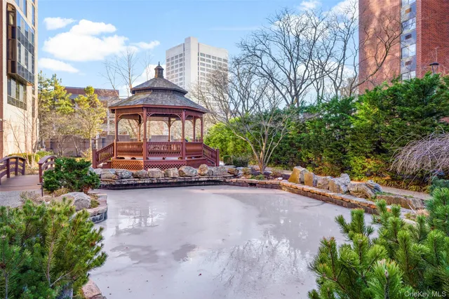 a front view of a house with yard and lake view