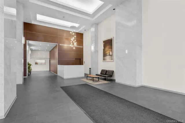 a hallway with a view of living room with furniture