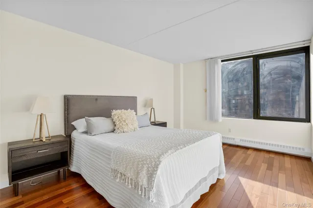 a bedroom with a bed and a large window