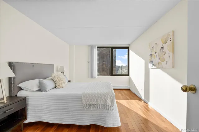 a bedroom with a large bed and a window