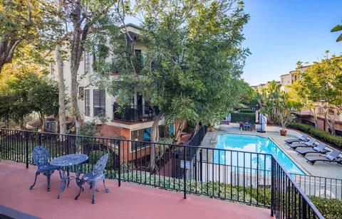 a view of a patio with iron fence