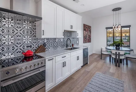 a kitchen with stainless steel appliances a stove microwave and cabinets
