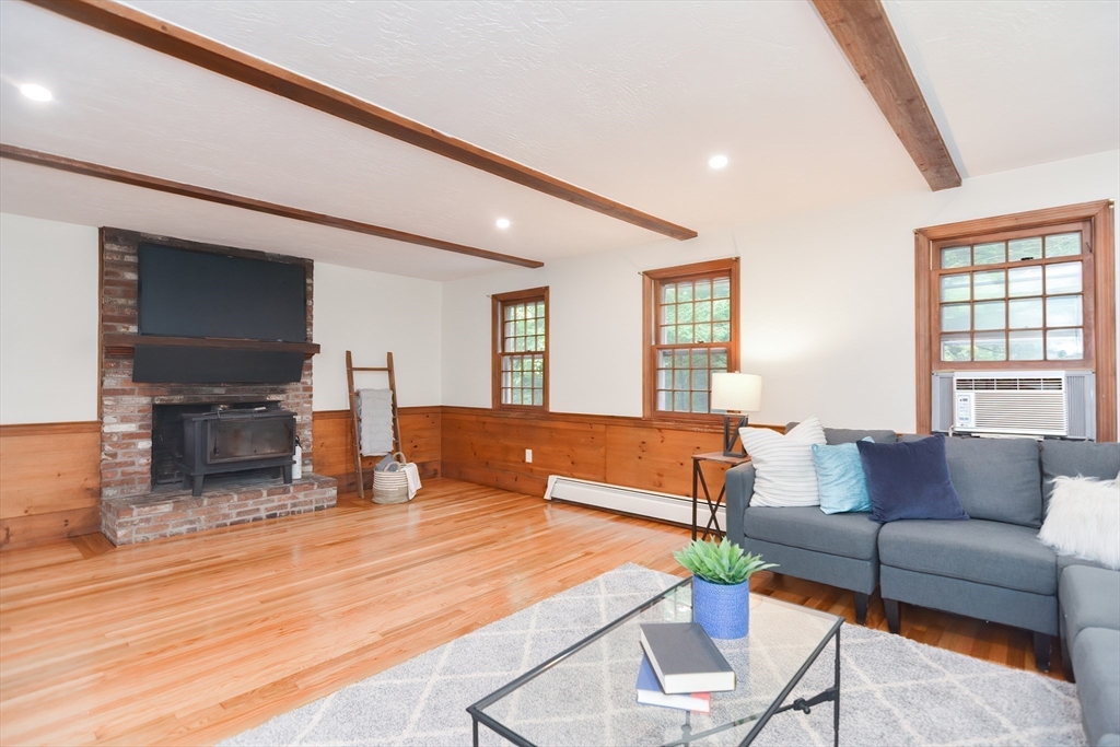 156 Wheeler Road Hollis, NH 03049 - Photo 18 of 42 a living room with furniture and a flat screen tv