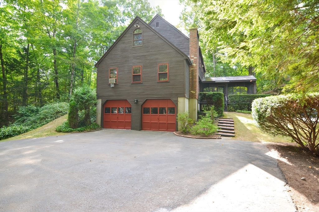 156 Wheeler Road Hollis, NH 03049 - Photo 2 of 42 a front view of a house with a yard and garage