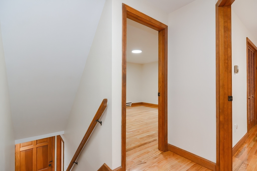 156 Wheeler Road Hollis, NH 03049 - Photo 26 of 42 a view of a hallway with wooden floor and staircase