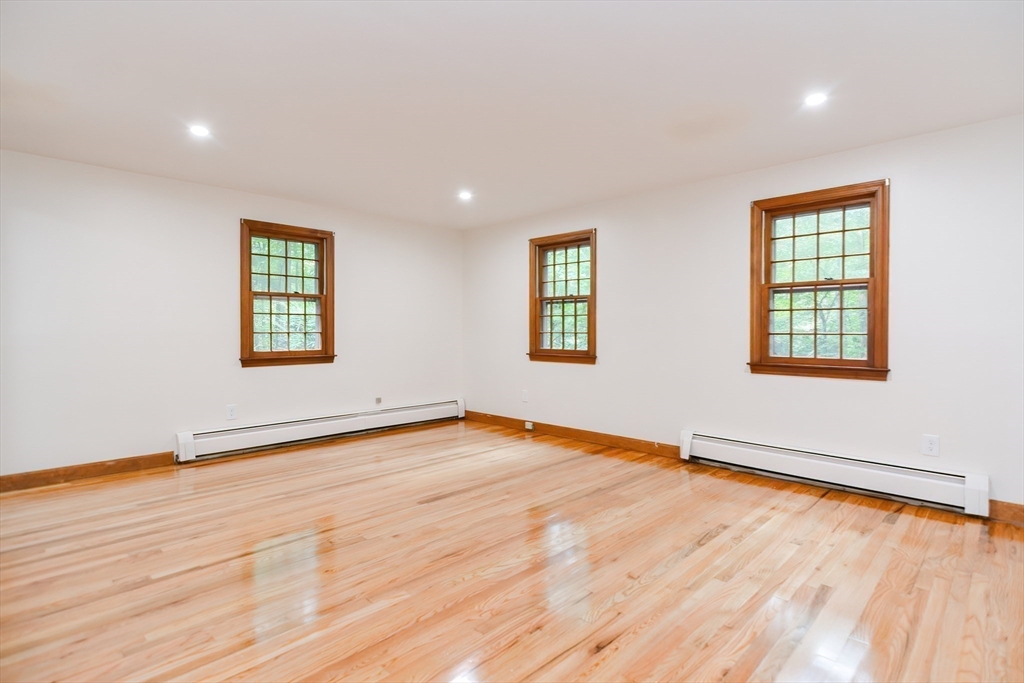 156 Wheeler Road Hollis, NH 03049 - Photo 27 of 42 an empty room with wooden floor and windows