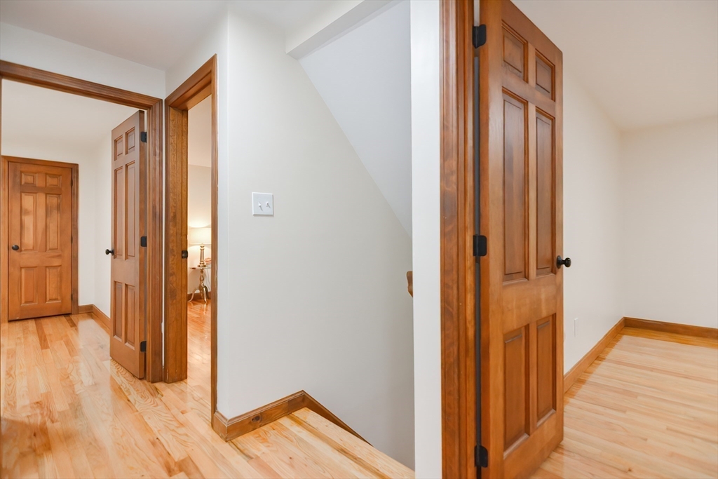 156 Wheeler Road Hollis, NH 03049 - Photo 31 of 42 a view of a hallway with wooden floor