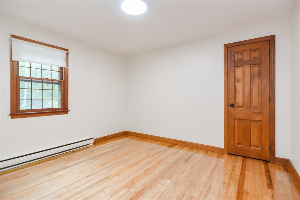 156 Wheeler Road Hollis, NH 03049 - Photo 32 of 42 an empty room with wooden floor and windows