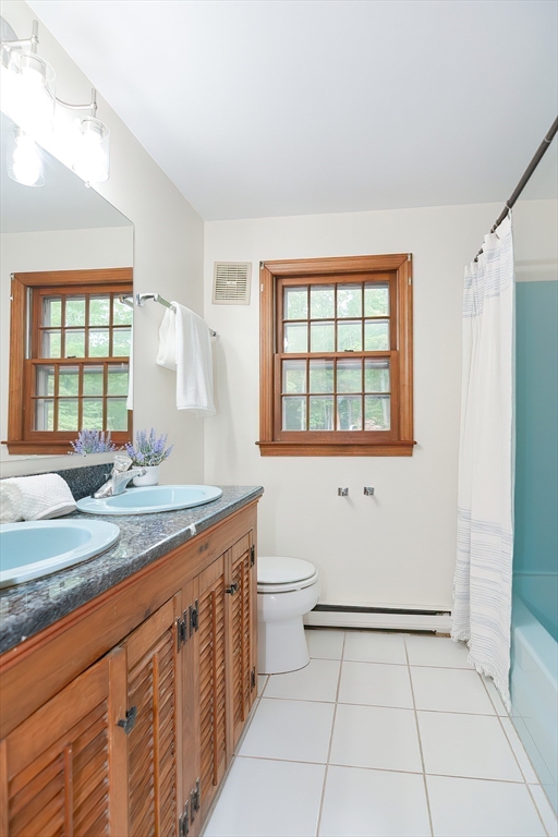 156 Wheeler Road Hollis, NH 03049 - Photo 33 of 42 a bathroom with a granite countertop sink a toilet and a window