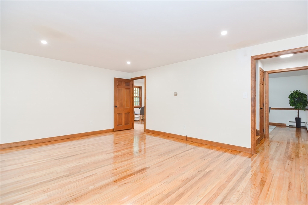 156 Wheeler Road Hollis, NH 03049 - Photo 6 of 42 a view of an empty room with wooden floor