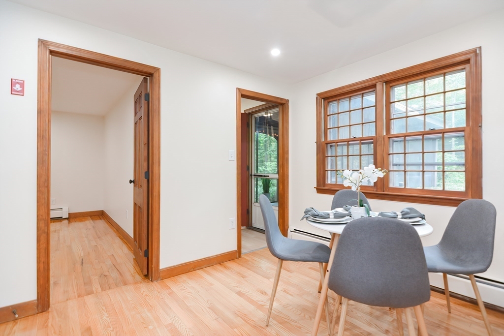 156 Wheeler Road Hollis, NH 03049 - Photo 9 of 42 a dining room with furniture and wooden floor