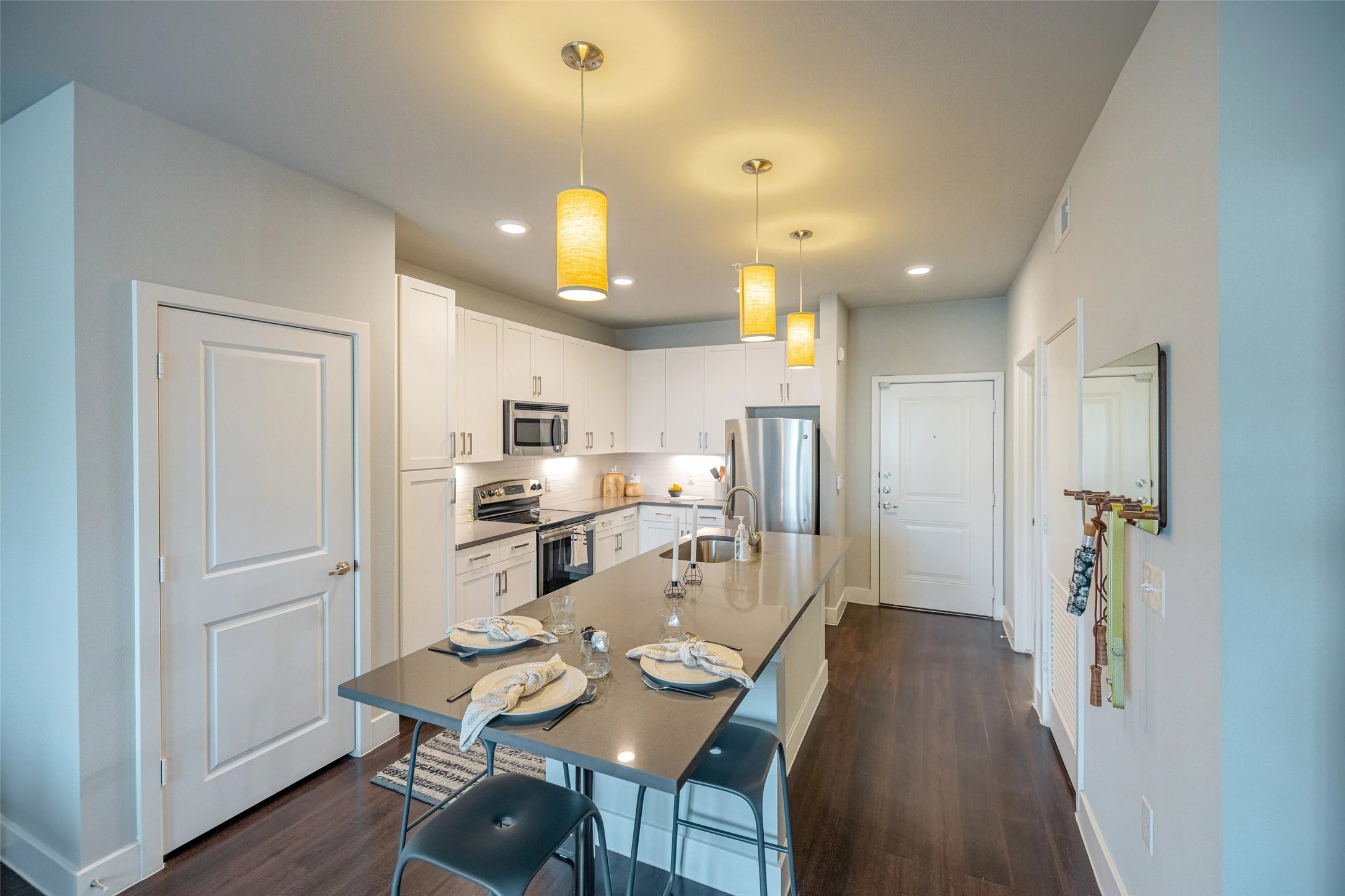 4800 Steiner Ranch Boulevard, Unit 12207 Austin, TX 78732 - Photo 16 of 19 a view of a dining room and livingroom with furniture wooden floor a chandelier